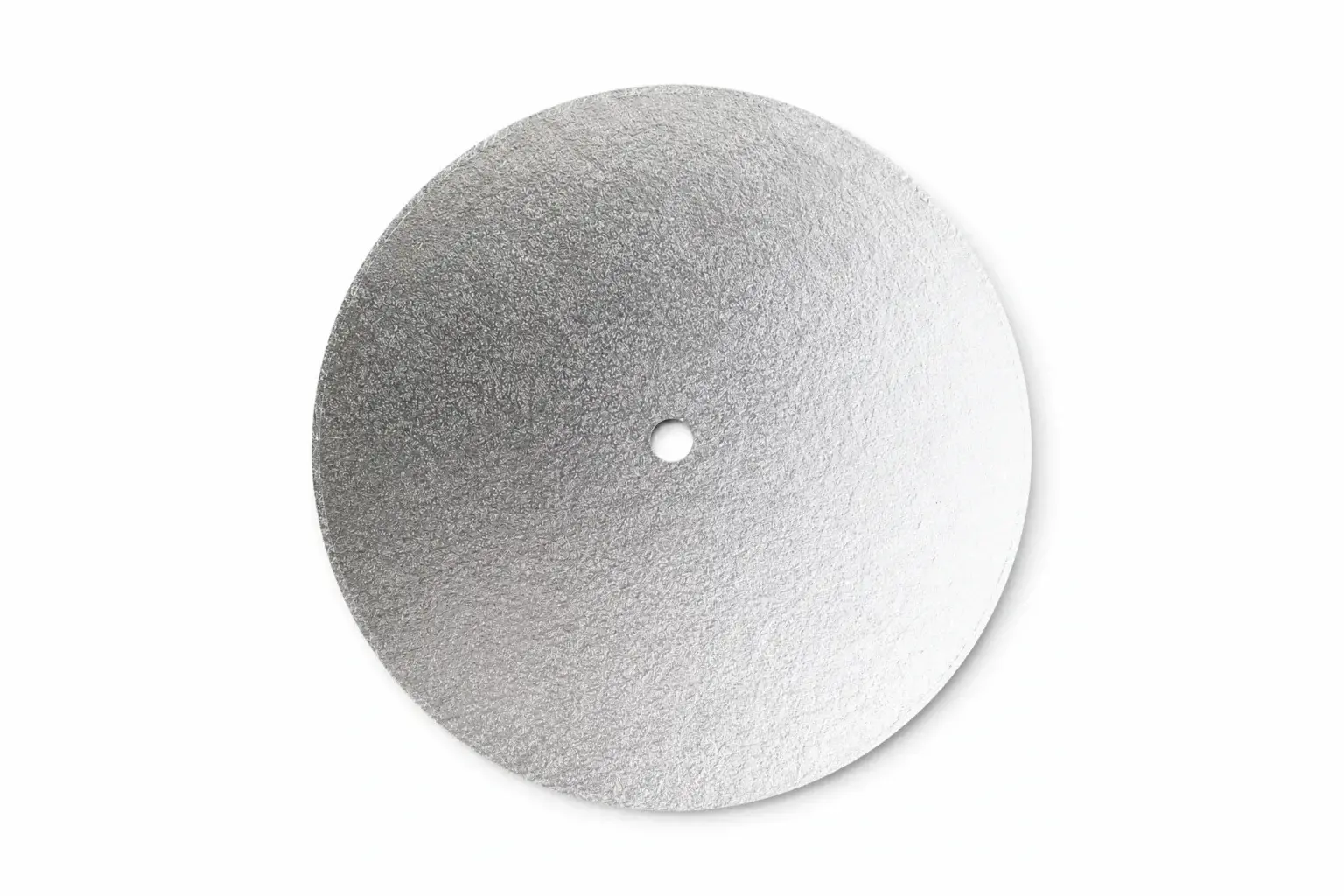 A round silver cake board seen from above, with the centre hole already cut.