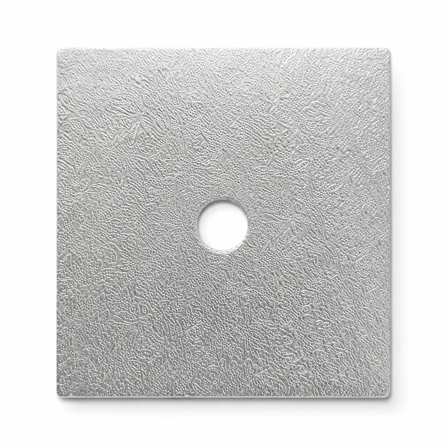 A square silver foil-wrapped cake drum seen from above, with the centre hole already cut